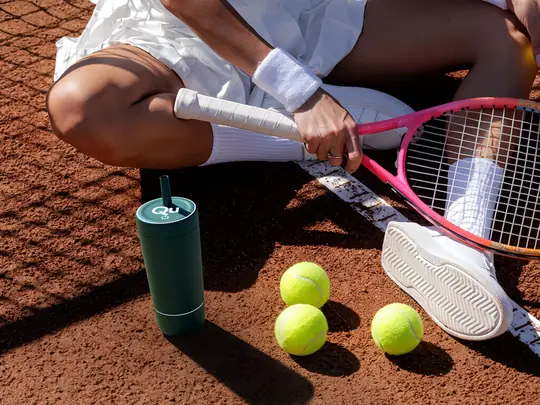 A Quantum Bottle resting courtside partway through a tennis match
